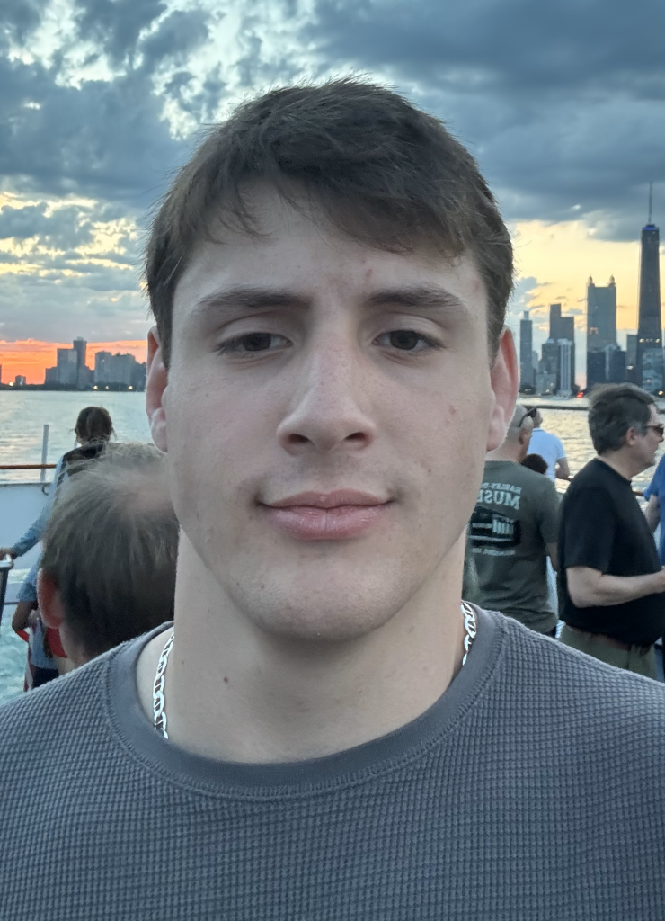 photo of Ethan Volpe in front of a city skyline at sunset